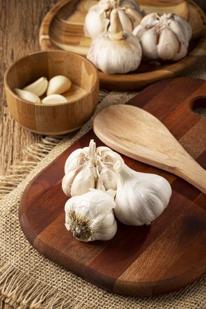 Garlic bulb and garlic cloves on the wooden table.