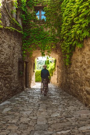Woman walking in a narrow path in a village