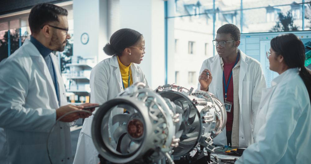 Team of Industrial Engineers Working on a Futuristic Green Energy Jet Engine, Discussing in Scientific Technology Lab.