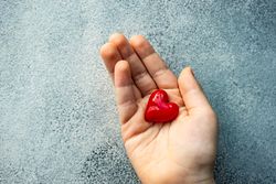 Hand holding heart decoration