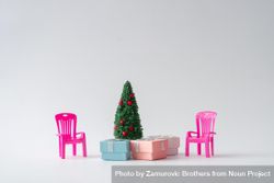 Christmas tree with presents underneath and pink chair 0LP1y0