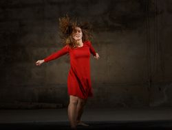 Young woman dancing in darkness