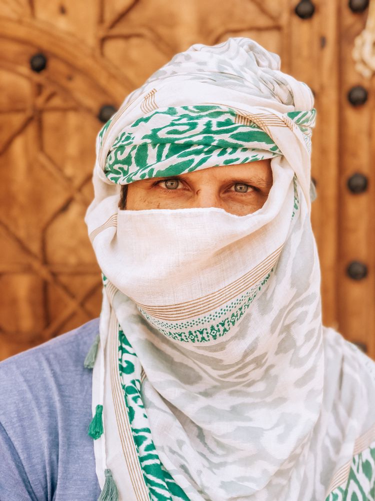 Man covering his head with scarf outdoor