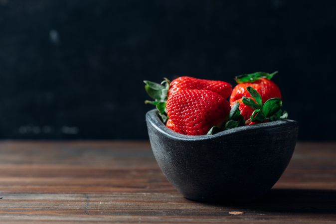 Fresh ripe strawberries in concrete bowl