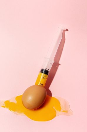 Syringe sucking yolk out of raw egg