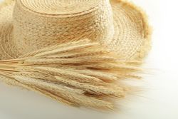 Dried bouquet of flowers next to thatch hat