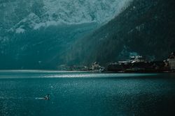 Lonely empty pier in turquoise water along mountain