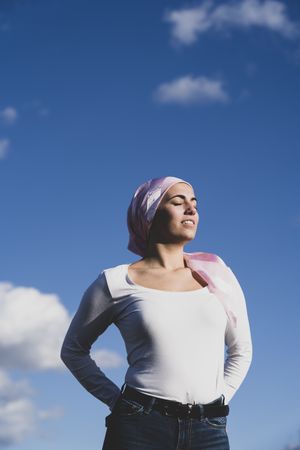 Young woman with hair in cancer bandana