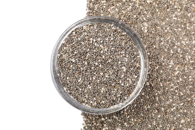 Chia seeds and glass bowl isolated on neutral background