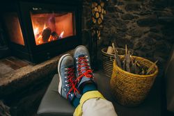 Boots resting by a warm fire place