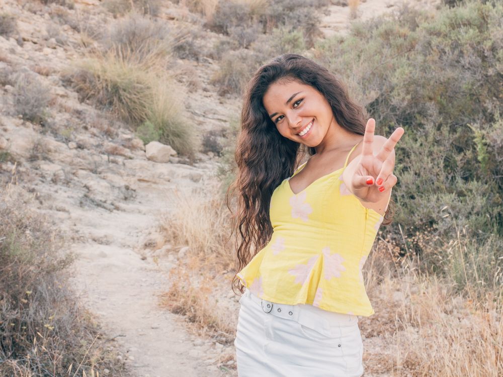 Playful trendy young woman in deserted countryside