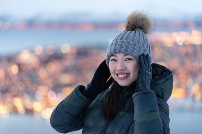 Joyful millennial woman enjoying view of night city