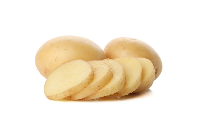 Side view of whole and sliced potato