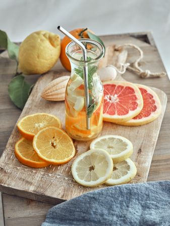 Bottle of refreshing drink and fruits