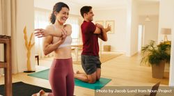 Couple smiling and exercising at home together 5zd6Xb