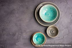 Three plates and bowls on grey background 42ree4