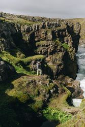 Man looking up from edge of cliff