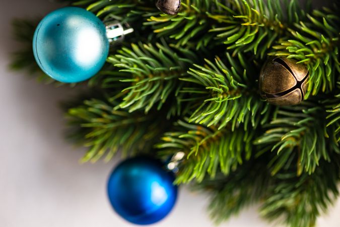 Close up of holiday wreath with blue baubles on marble counter
