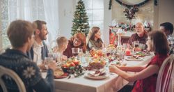 Multi-Generational Family Members Share Funny Stories and Joy During a Christmas Turkey Dinner.