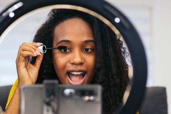 Beauty blogger promoting makeup on social media