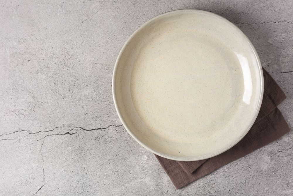 Empty plate on the slate table. Top view of the image.