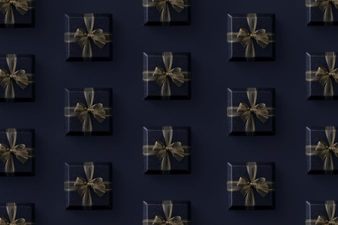 Gift boxes with gold ribbon on dark background