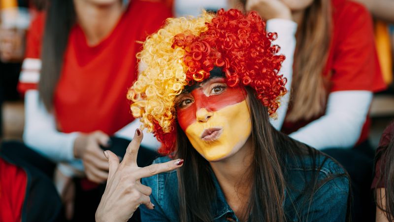 German soccer supporter in stadium looking at camera