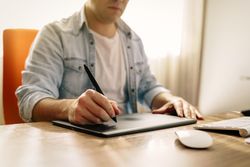 Man drawing on a tablet