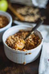 Baked apple crumble in ramekin bowl