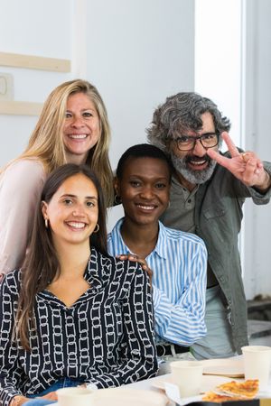 Cheerful diverse coworking women looking at camera