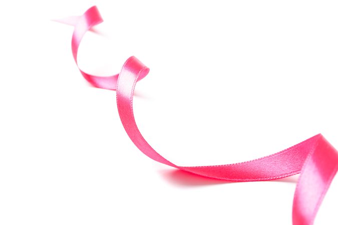 Pink ribbon isolated on plain background. Gift concept