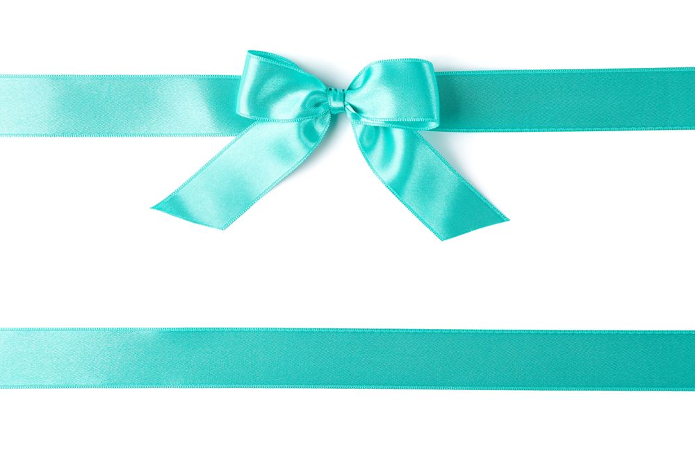 Turquoise ribbons with bow isolated on plain background. Gift concept
