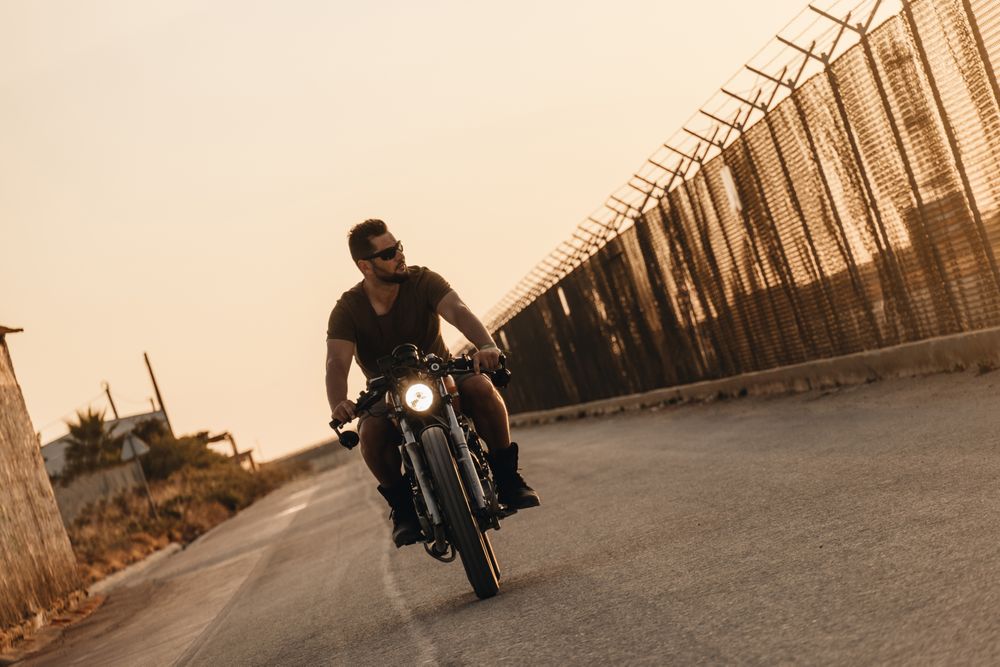 Strong man driving motorcycle