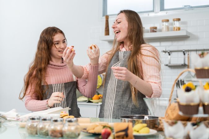 Happy mother & daughter preparing dessert together