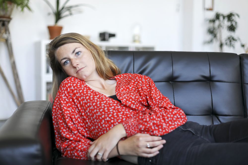Calm young blond woman chilling out sofa