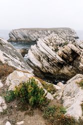 Rocky formations in the island of Baleal on the Atlantic coast in a foggy day. Peniche, Portugal