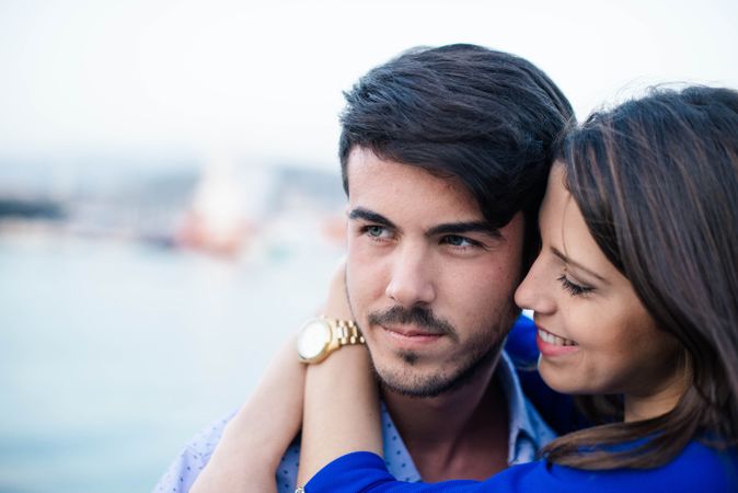 Loving couple embracing on urban pier with dock