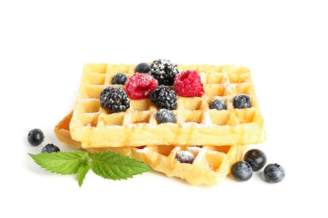 Waffles with berries and mint isolated on blank background