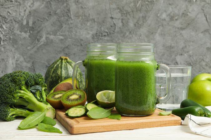 Concept of healthy food with smoothie, vegetables and fruits on wooden table