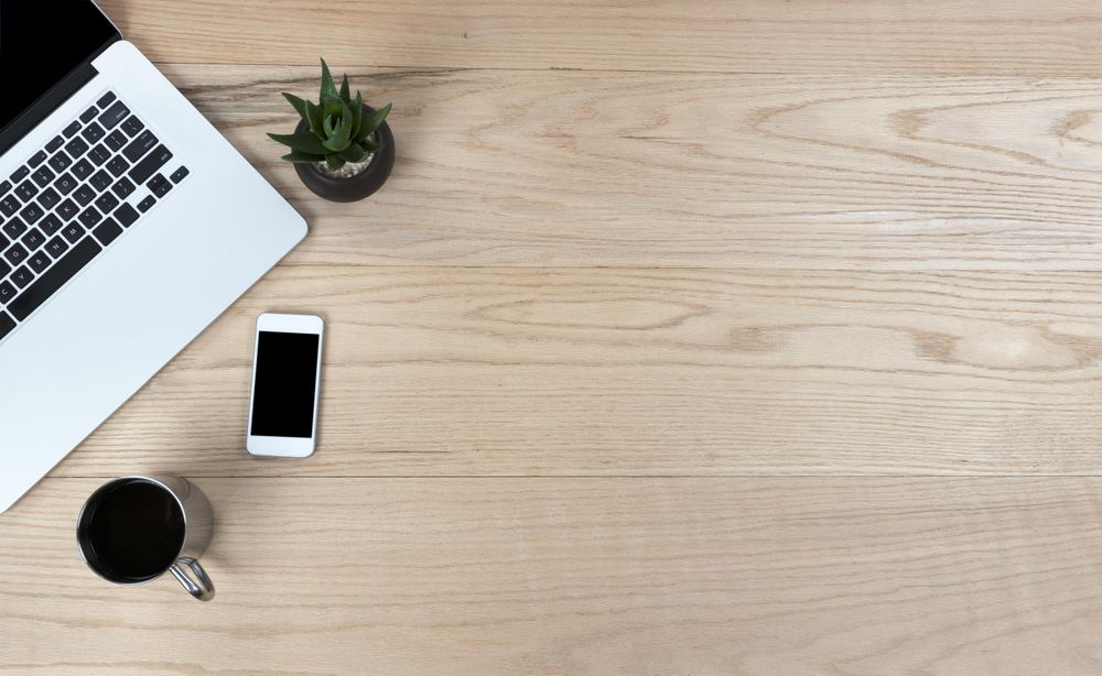 Desktop table with mobile devices and coffee