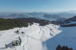 Snowy ski resort on mountains in sunlight