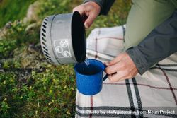 Person pouring coffee at campsite 5oPYz4