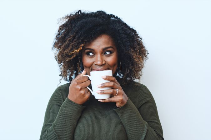 Black woman smiling with cup of coffee