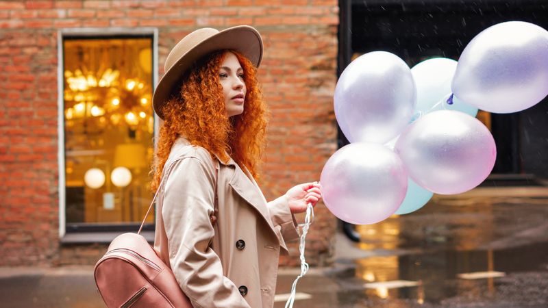 Woman walking outside with balloons