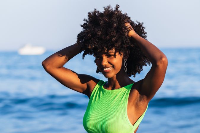 Black woman standing in sea during summer vacation