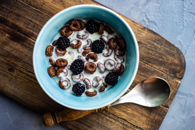 Traditional breakfast with chocolate cereal in bowl with milk
