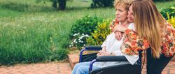 Mature woman in a wheelchair with her daughter