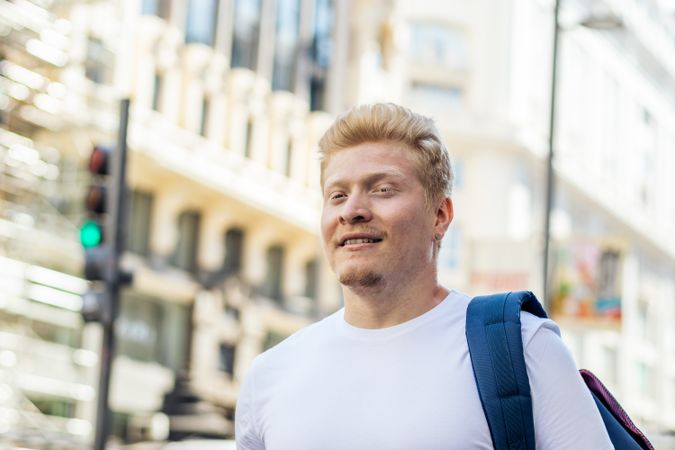 Close-up of Latino man with albinism outside,  in the city street.