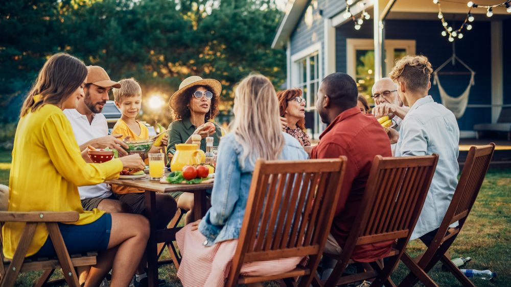 Relatives and Friends Gathered Outside Their Home on Warm Summer Day.