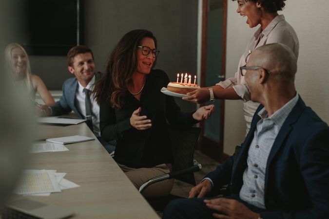 Surprise birthday celebration of a female during office meeting